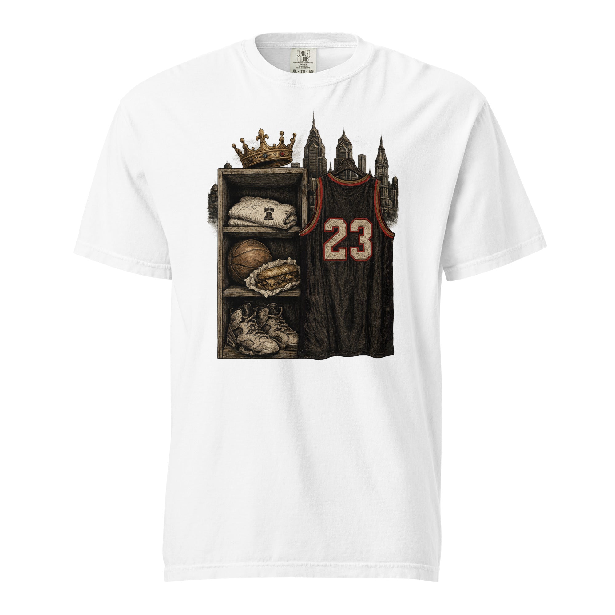 A white short-sleeve crewneck t-shirt featuring a detailed graphic print on the front. The graphic depicts a basketball-themed locker room scene with a dark jersey numbered 23, a crown, a basketball, a baseball glove, and sneakers.