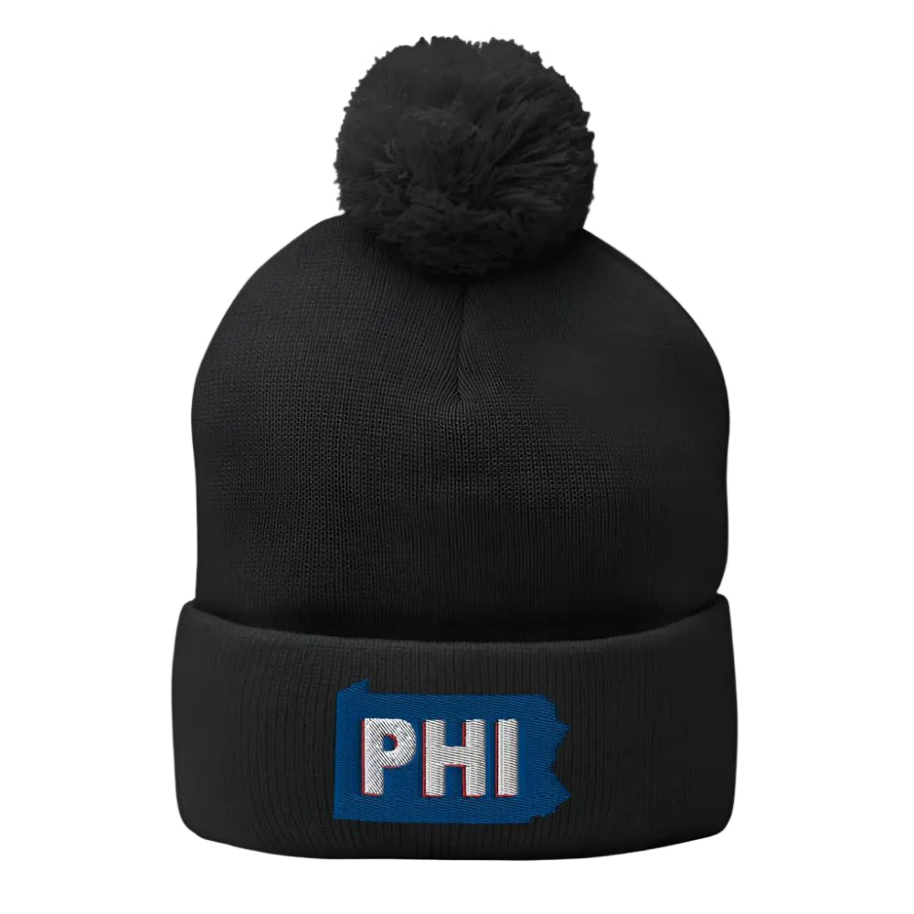 Black knit beanie with pom on top and the shape of Pennsylvania with the letters "PHI"
