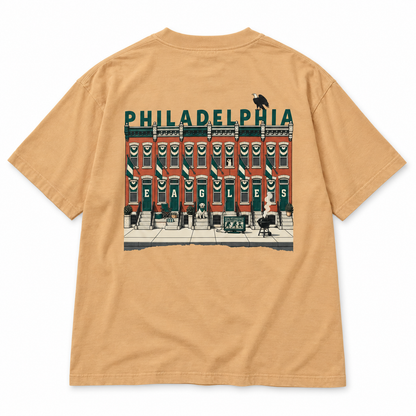 Birds on the Block Tee in sand — back view, full back print of illustrated South Philly rowhouses dressed for game day with PHILADELPHIA across the roofline, Philly Drinkers
